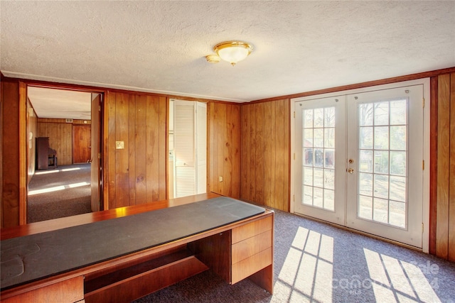 mudroom featuring carpet floors, a textured ceiling, and french doors