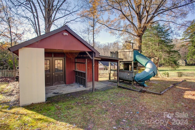 rear view of property with an outdoor structure