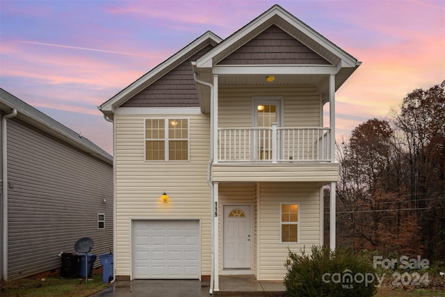 view of front facade with a balcony and a garage