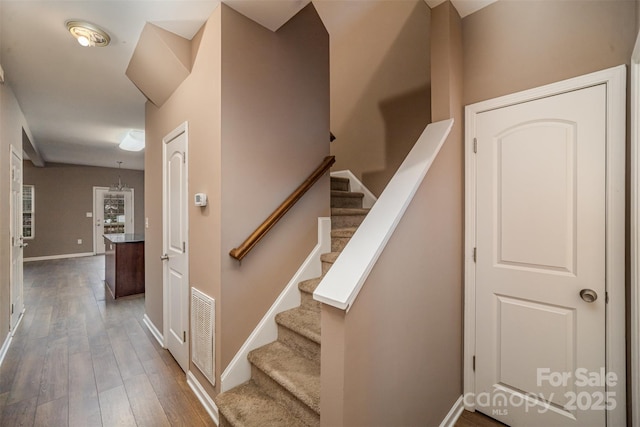 stairs with wood-type flooring