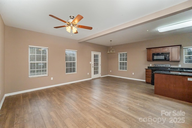 kitchen featuring pendant lighting, ceiling fan, light hardwood / wood-style floors, and electric range