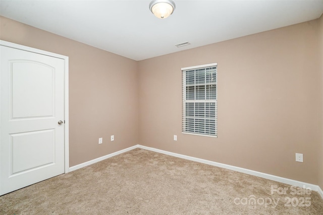 unfurnished room with light colored carpet