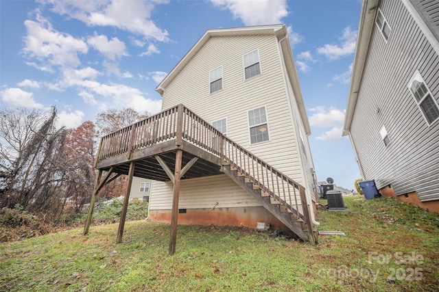 rear view of property with cooling unit, a yard, and a deck