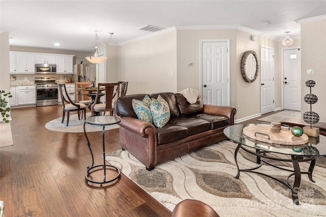 living room with crown molding and dark hardwood / wood-style floors