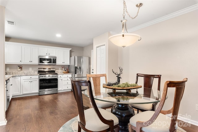 dining room with dark hardwood / wood-style flooring and ornamental molding