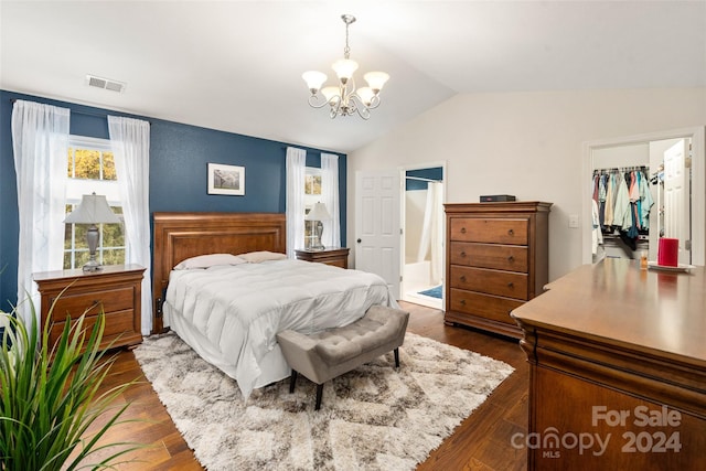 bedroom featuring a spacious closet, a closet, dark wood-type flooring, and vaulted ceiling