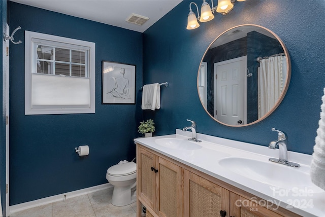 bathroom featuring tile patterned flooring, vanity, and toilet