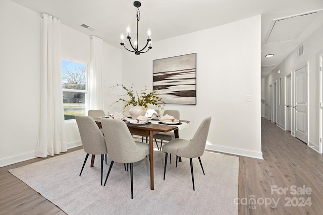 dining space featuring a notable chandelier and hardwood / wood-style flooring