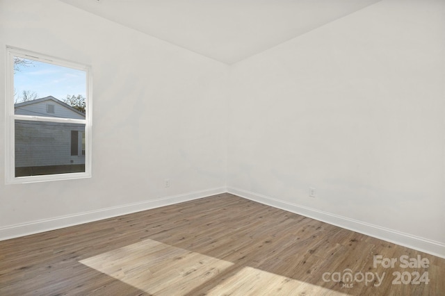 spare room with wood-type flooring