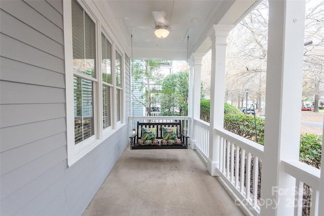 balcony with covered porch and ceiling fan