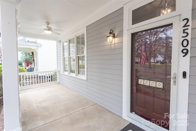 doorway to property featuring ceiling fan