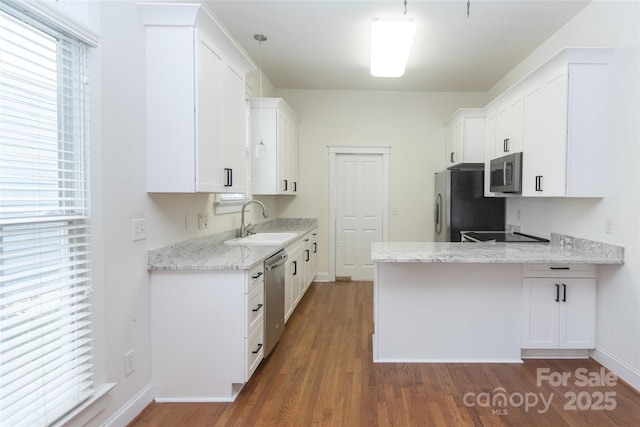 kitchen with sink, white cabinets, and decorative light fixtures