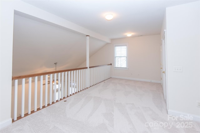 additional living space featuring light colored carpet and lofted ceiling