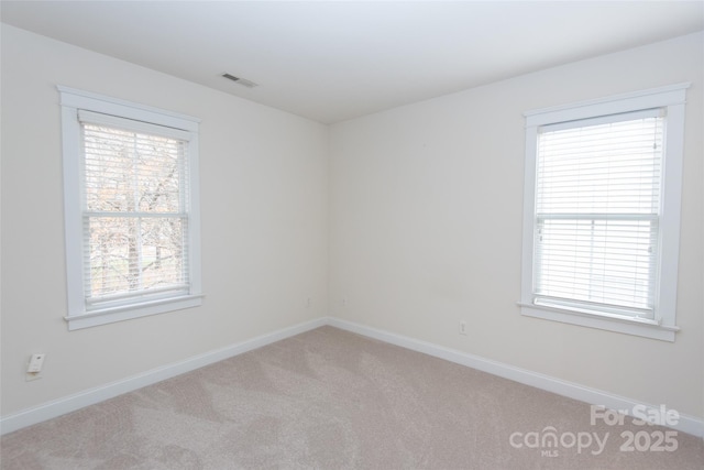 carpeted empty room featuring a healthy amount of sunlight