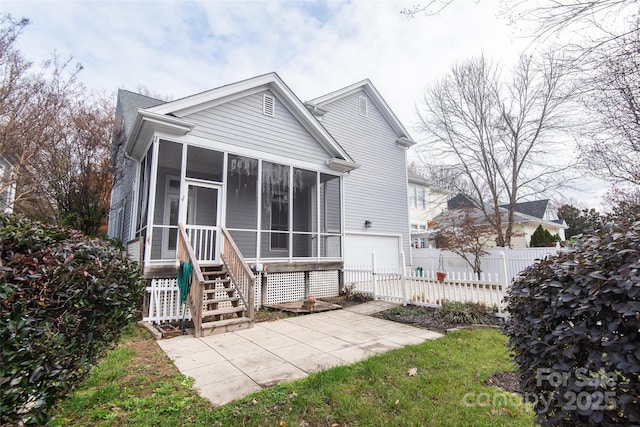 rear view of house featuring a sunroom