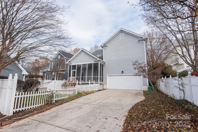 back of house with a sunroom and a garage