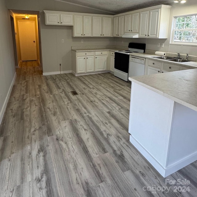 kitchen featuring sink, white cabinets, and light hardwood / wood-style floors