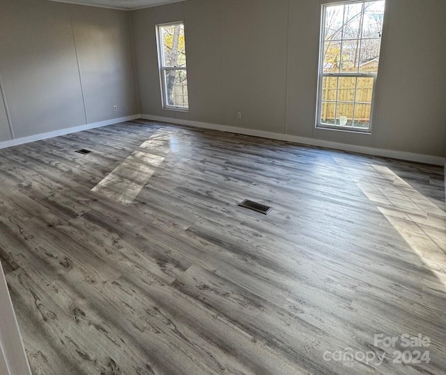 unfurnished room with hardwood / wood-style floors