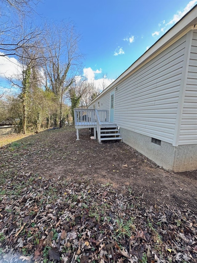 view of yard with a wooden deck