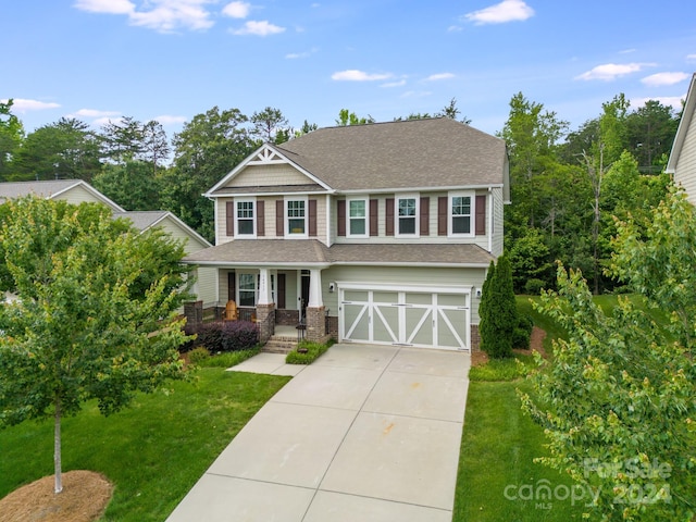 view of front of property with a front lawn and a garage