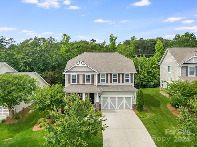 view of front of house featuring a front yard and a garage