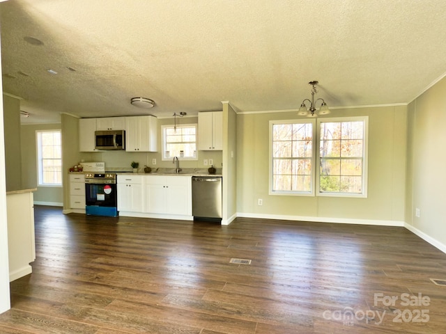 kitchen featuring pendant lighting, sink, appliances with stainless steel finishes, white cabinetry, and dark hardwood / wood-style flooring