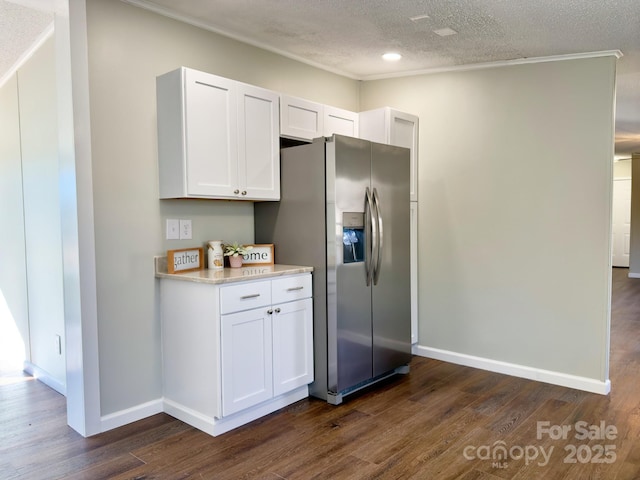 kitchen featuring dark wood-type flooring, stainless steel fridge with ice dispenser, a textured ceiling, and white cabinets