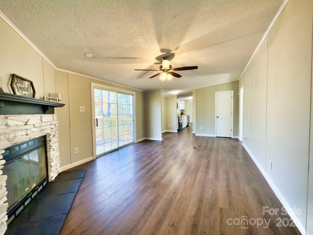 unfurnished living room with a fireplace, dark hardwood / wood-style flooring, ornamental molding, ceiling fan, and a textured ceiling