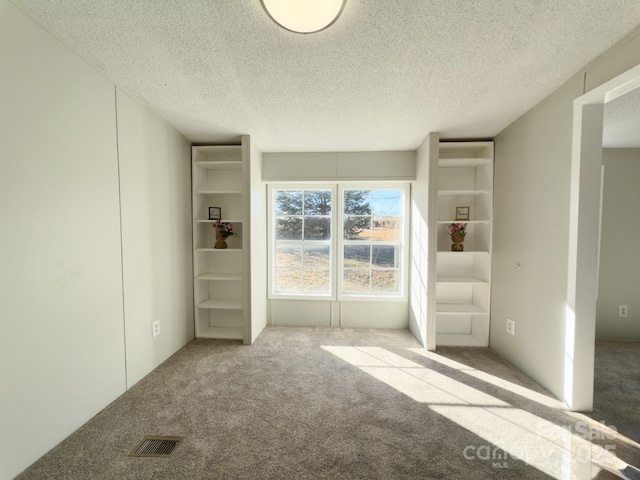 unfurnished bedroom with carpet and a textured ceiling