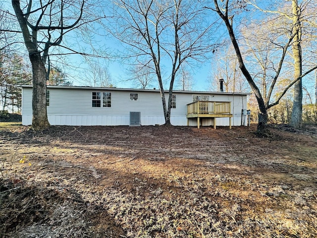 back of house featuring central AC unit and a deck