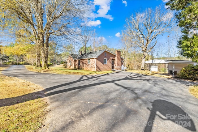 ranch-style house featuring an outbuilding and a garage