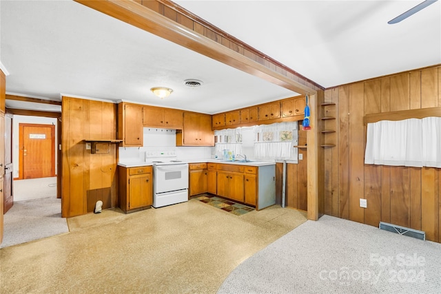 kitchen featuring wooden walls, sink, ceiling fan, and white electric stove