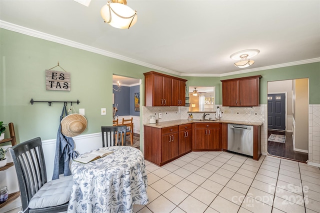 kitchen with dishwasher, light tile patterned flooring, ornamental molding, and sink