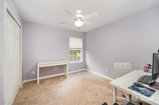 carpeted home office with ceiling fan