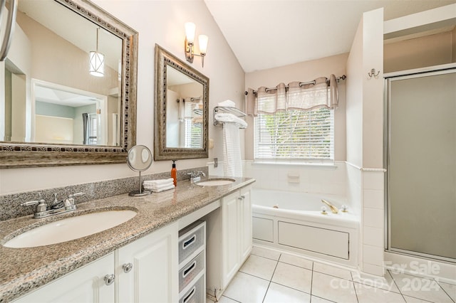 bathroom with tile patterned flooring, vanity, vaulted ceiling, and plus walk in shower