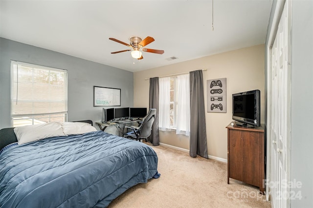 carpeted bedroom featuring a closet and ceiling fan