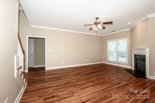 131 Quail Haven Dr, Troutman, NC 28166 - unfurnished living room featuring wood finished floors, ceiling fan, ornamental molding, stairway, and a fireplace with flush hearth