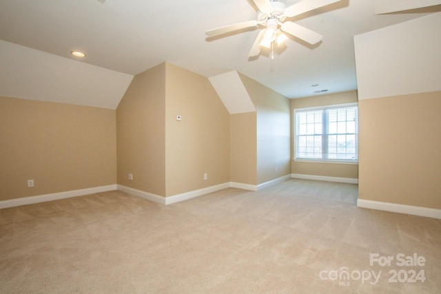 bonus room featuring ceiling fan, light carpet, and vaulted ceiling