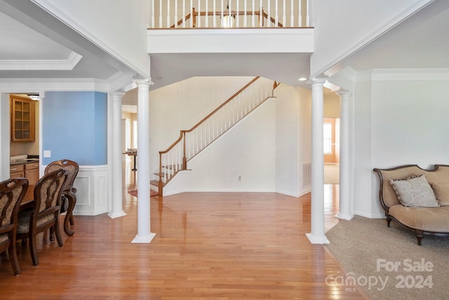 entryway with wood-type flooring and ornamental molding