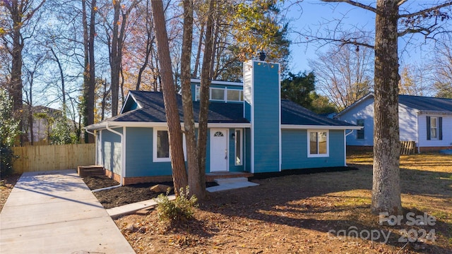 2515 Dion Ave, Charlotte, NC 28212 - view of front facade featuring a chimney, driveway, and roof with shingles