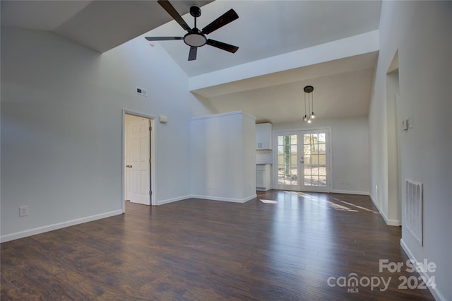 unfurnished living room with ceiling fan, dark wood-type flooring, high vaulted ceiling, and french doors