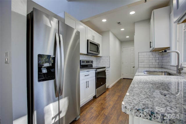 2515 Dion Ave, Charlotte, NC 28212 - kitchen with stainless steel appliances, light stone countertops, decorative backsplash, recessed lighting, and dark wood finished floors
