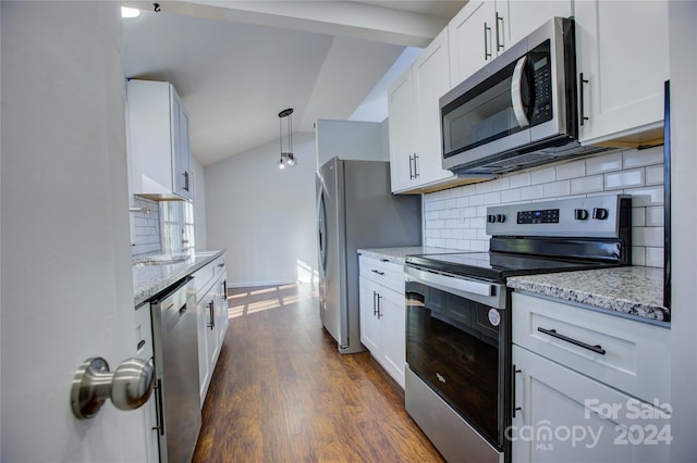 kitchen with dark hardwood / wood-style floors, white cabinets, stainless steel appliances, and vaulted ceiling