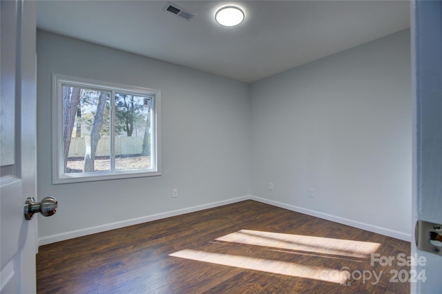 unfurnished room featuring dark hardwood / wood-style flooring