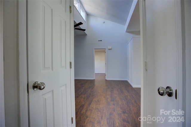 hallway featuring dark hardwood / wood-style flooring and high vaulted ceiling