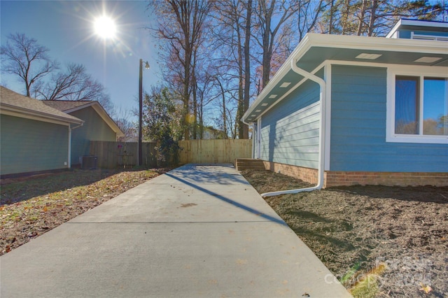 view of property exterior with a patio and central AC unit