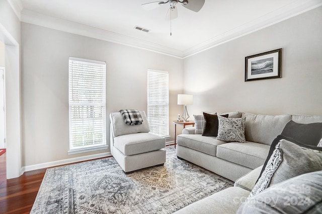 living room featuring hardwood / wood-style floors, ceiling fan, and crown molding