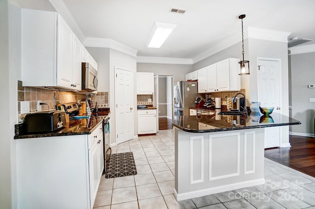 kitchen with white cabinetry, sink, stainless steel appliances, crown molding, and pendant lighting