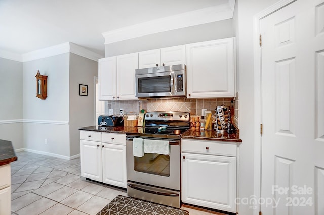 kitchen featuring white cabinets, light tile patterned floors, backsplash, and appliances with stainless steel finishes