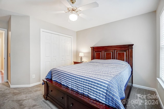 carpeted bedroom featuring ceiling fan and a closet